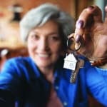 Close up blurred of happy elderly 60s grandmother show keys excited about house bank mortgage or lease, smiling mature woman tenant renter overjoyed to be home owner, relocation, rental concept