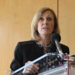 Massachusetts Taxpayers Foundation President Eileen McAnneny speaks from a podium