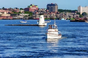 New Bedford, Massachusetts, USA - August 3, 2019: Yacht outbound in New Bedford inner harbor on a summer morning
