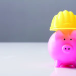 Close-up Of A Piggy Bank With Hard Hat