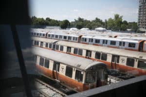 Old and new Orange Line trains sit in the MBTA's Wellington repair yard in August 2022.