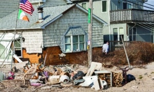 A man walks through the ruins of New York City’s Breezy Point a month after Hurricane Sandy slammed into the city in the fall of 2012.