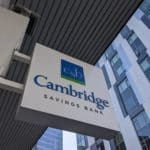 A Cambridge Savings Bank sign over the lender's Kendall Square ATM