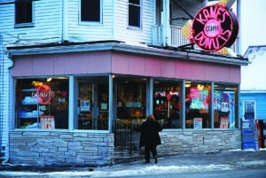 Saugus, MA, USA February 5, 2009 An adult woman walks into Kane's Donuts in Saugus, Massachusetts. The pastry shop has been a staple of the blue collar community since 1955.