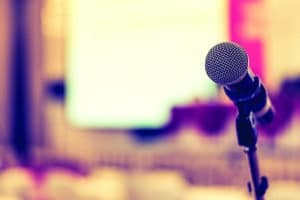 Microphone voice speaker in business seminar, speech presentation, town hall meeting, lecture hall or conference room in corporate or community event for host or public hearing
