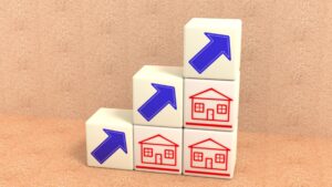 3D illustration of cubes with arrow and houses symbols stacked in a pyramid, with arrows pointing up