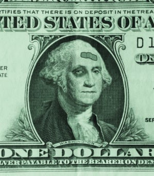 Photo illustration of George Washington on a dollar bill sporting a black eye and a band-aid, as the weak dollar takes a beating.