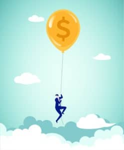 businessman clinging to string of dollar-shaped balloon above the clouds