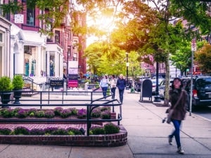 The famous Newbury street in Boston, Massachusetts, USA showcasing its expensive stores, fancy restaurants, and lots of shoppers passing by.