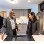 Roxbury resident Mark Kennedy, right, gives Boston Mayor Michelle Wu a tour of his recently-completed ADU on Oct. 18, 2023.