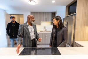 Roxbury resident Mark Kennedy, right, gives Boston Mayor Michelle Wu a tour of his recently-completed ADU on Oct. 18, 2023.