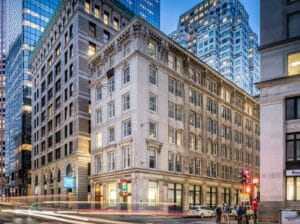 An evening photo of 12 Post Office Square in Boston.