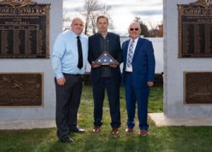 Robert Challinor, Jr., representative of the Putnam Veterans Advisory Committee, Robert J. Morton, president and CEO of BankHometown, and Barney Seney, mayor of Putnam, Connecticut, pose for a photo.