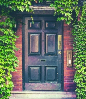 A Townhouse Door Surounded By Ivy In The Exclusive Beacon Hill Area Of Boston