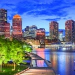 Boston, Massachusetts, USA downtown city skyline and pier at twilight.