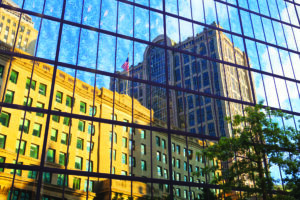 Boston, Massachusetts, USA - July 4,2016: Five Hundred Boylston Building in Boston is reflected in the glass of the Hancock Tower.