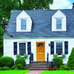 Westchester, NY - August 2023: Small white clapboard house with dormer windows