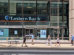 Pedestrians walk past Eastern Bank's branch on Franklin Street in downtown Boston on June 8, 2026.