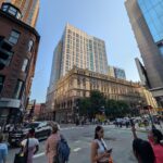 The sun-lit Kensington apartment tower in Boston's Theater District is shown from the corner of Essex and Washington Streets on the evening of July 8, 2026.