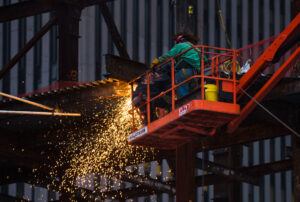 Workers in a cherry-picker welding steel beams and columns in Lower Manhattan in 2017